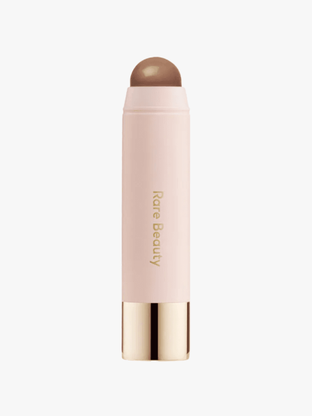 Rare Beauty Warm Wishes Effortless Bronzer Stick in branded component on a light gray background